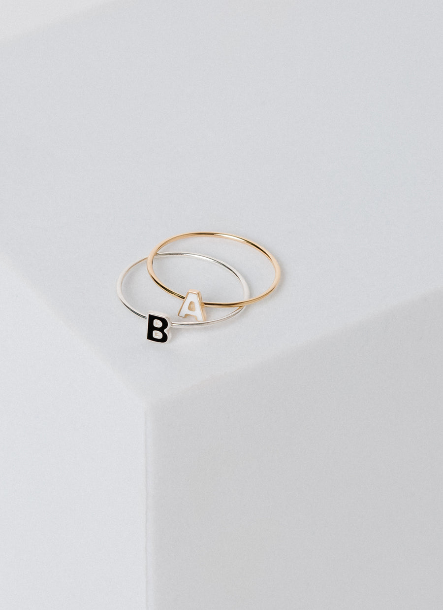 Enamel letter stacking rings from RIVA New York, available in both silver and 14k yellow gold