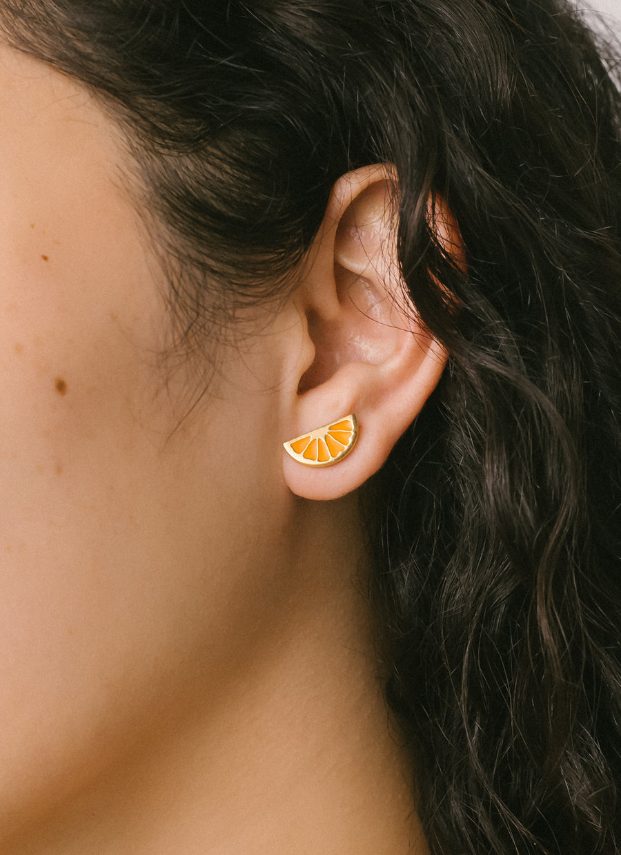 Gold vermeil citrus wedge stud earrings with orange enamel, from RIVA New York
