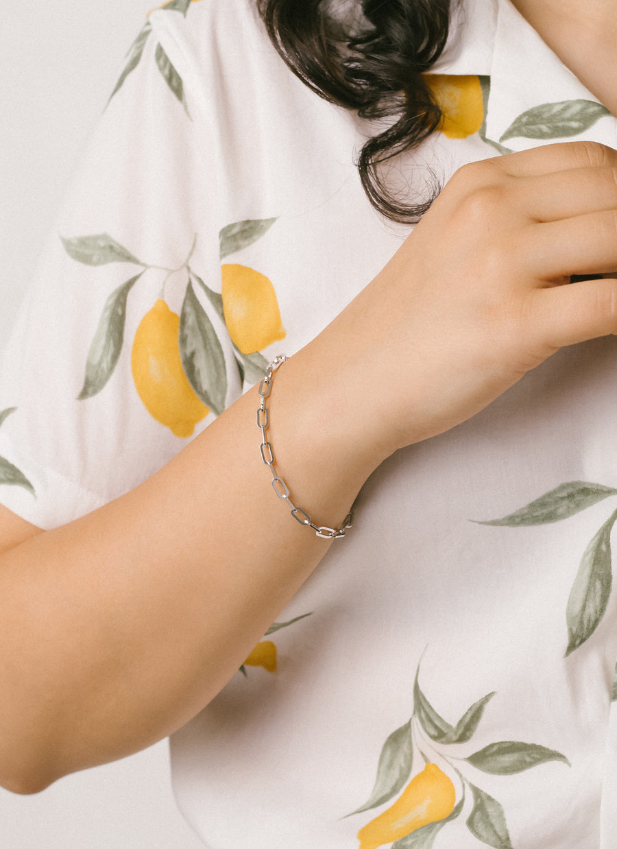 Model wearing RIVA New York's Astor paper clip chain bracelet in sterling silver