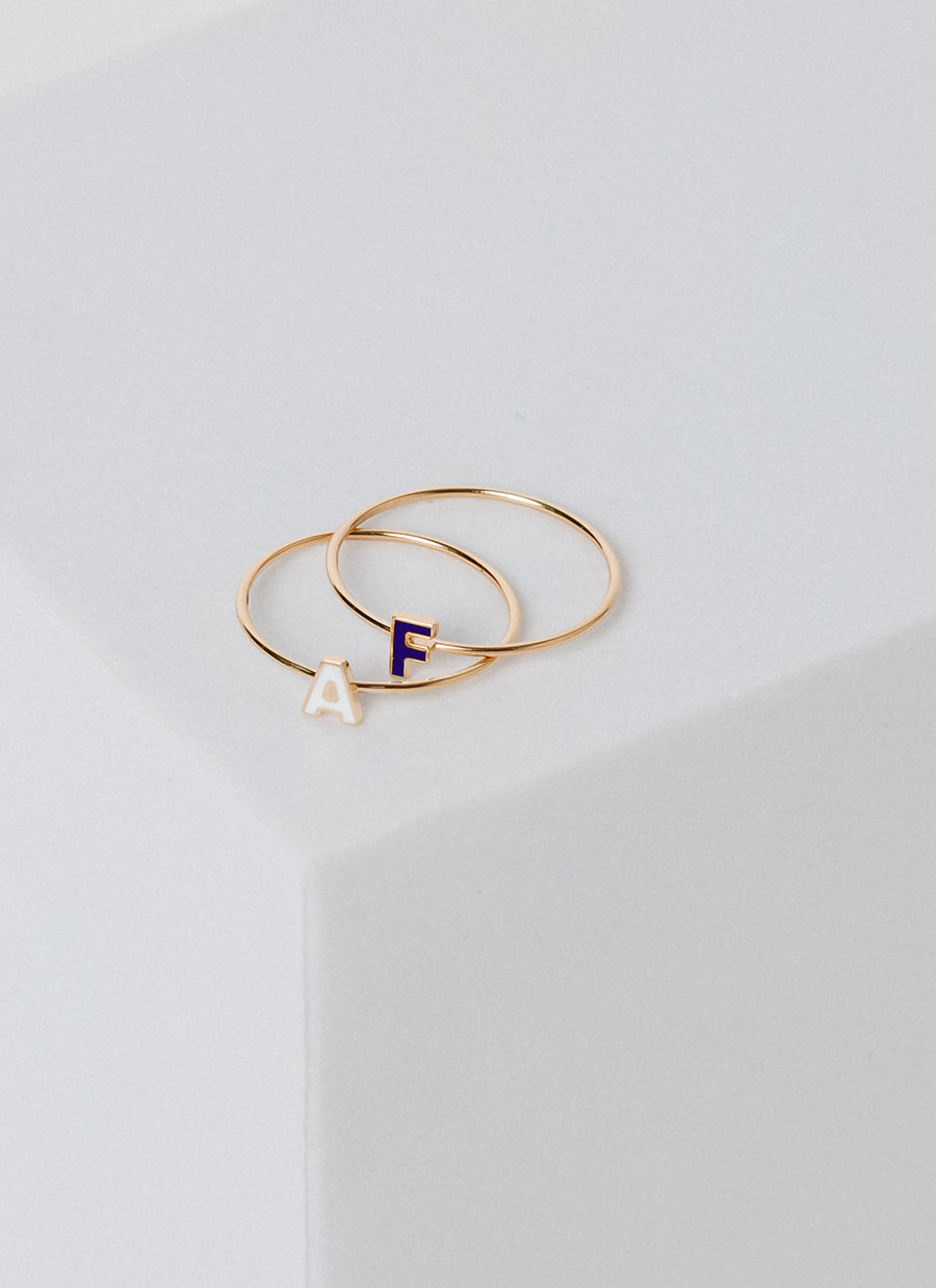 14K yellow gold stacker rings with enameled letter or initial accents, from RIVA New York