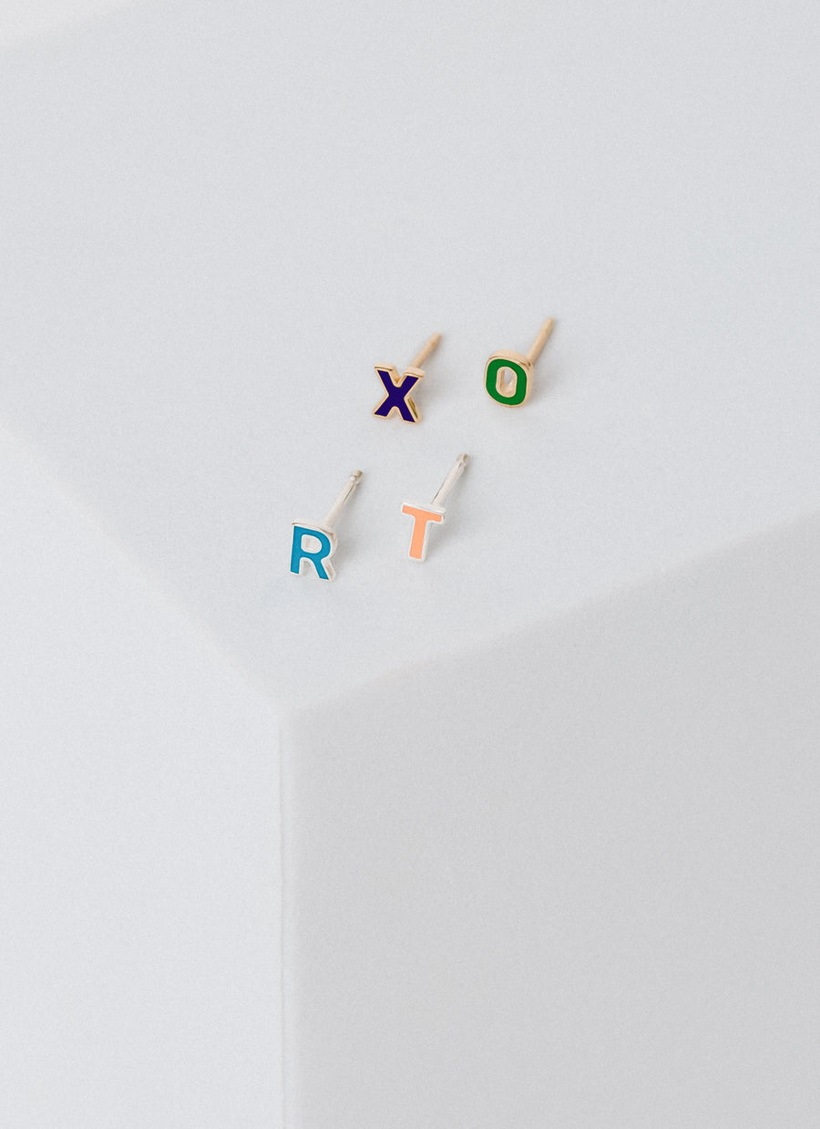Enamel letter stud earrings in 14-karat yellow gold and sterling silver, from RIVA New York Jewelry