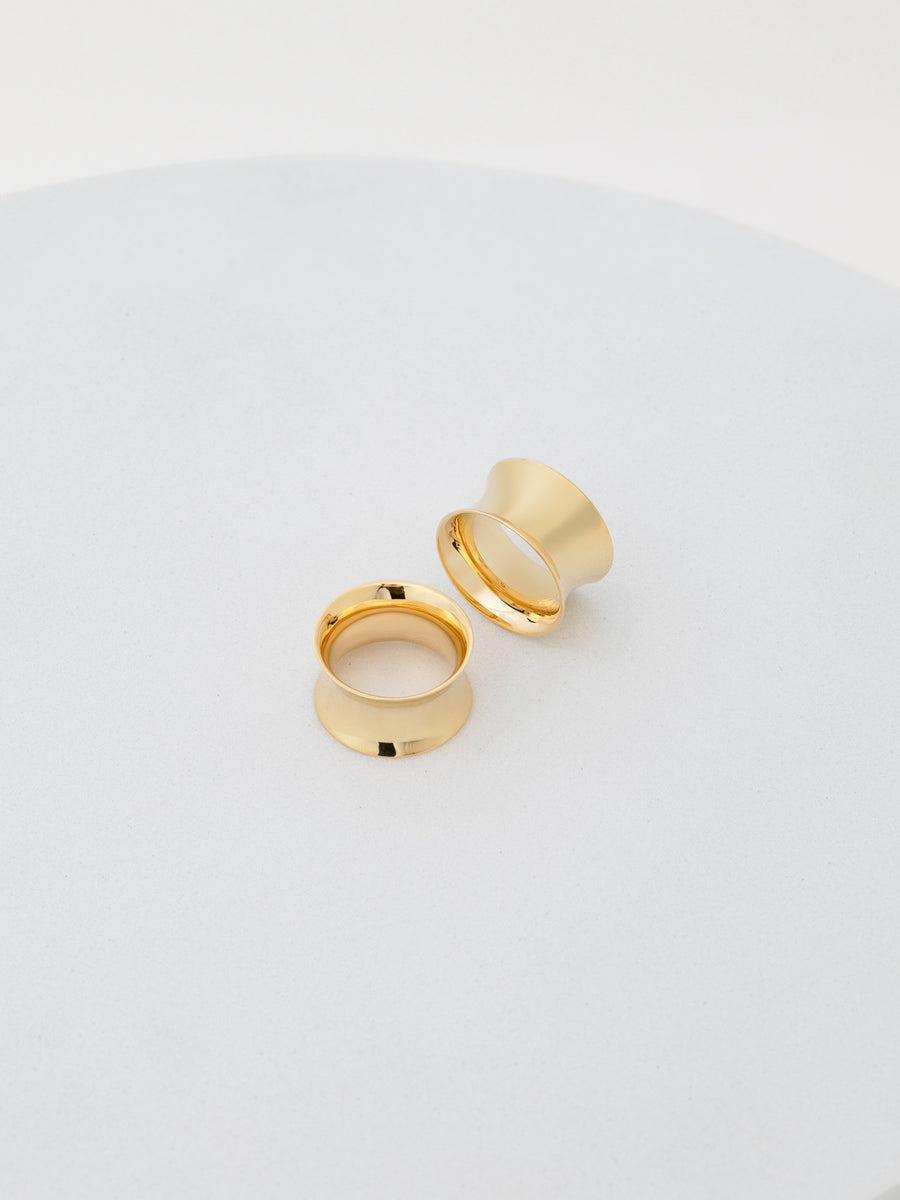 Photo of 1/2 in double flared tunnels in 14k yellow gold from RIVA New York