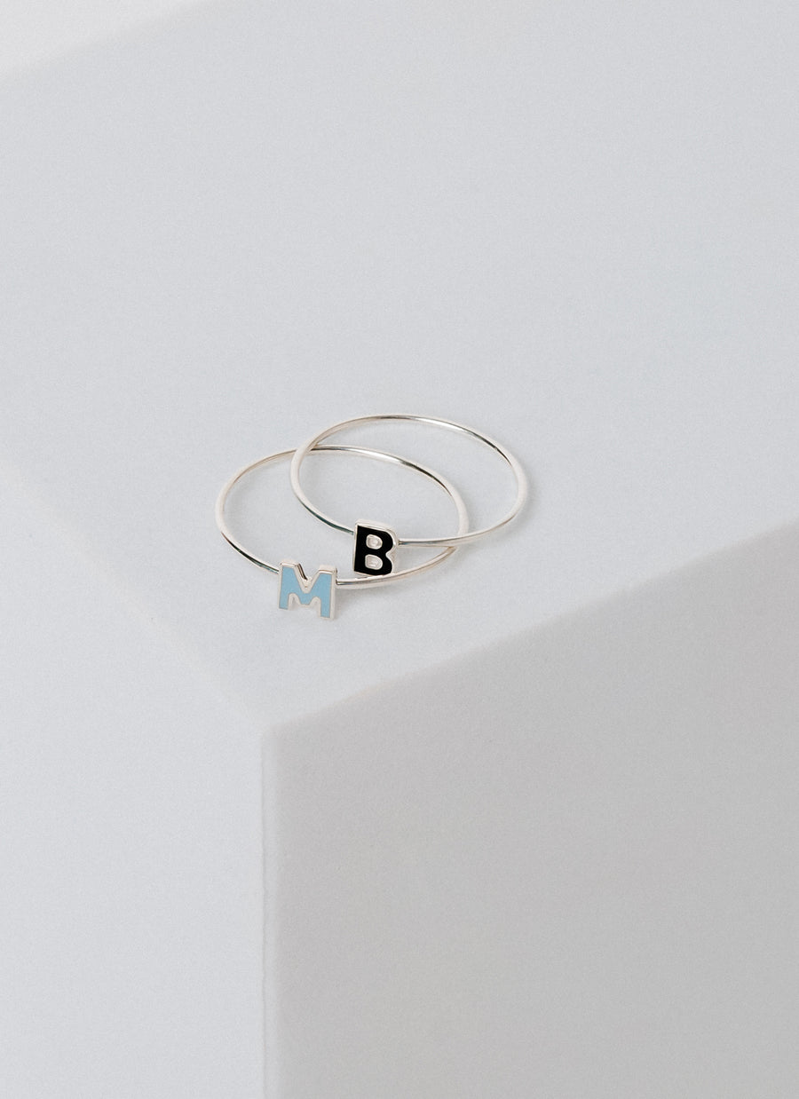 Sterling silver stacking rings with enameled letters, from RIVA New York
