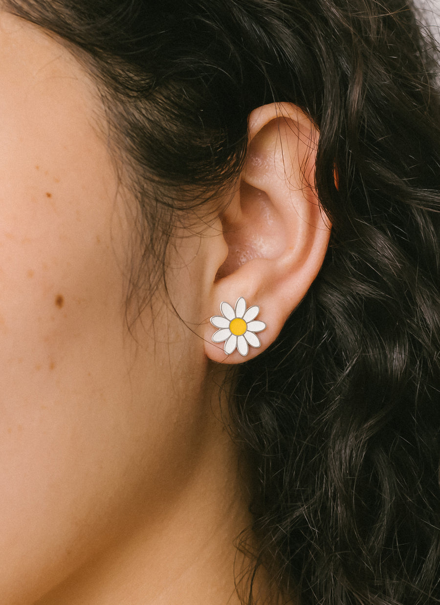 Model Celina wearing the daisy enamel stud earring in sterling silver, from RIVA New York