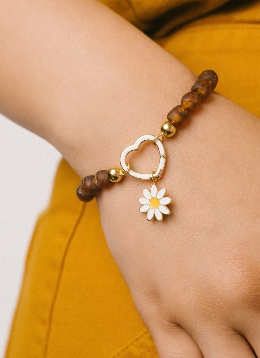 Daisy enamel charm from RIVA New York in yellow gold vermeil, worn here as bracelet charm