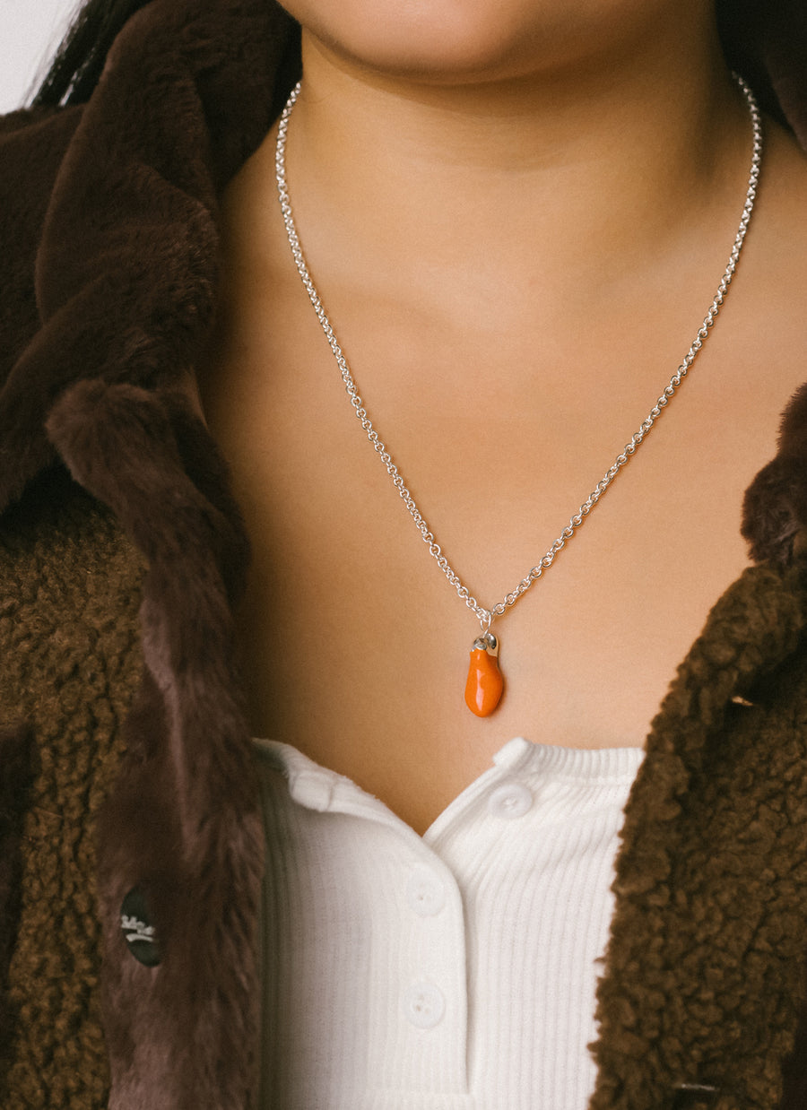 Model wearing large Coral Enamel-Dipped Baroque Silver Drop Necklace from RIVA New York