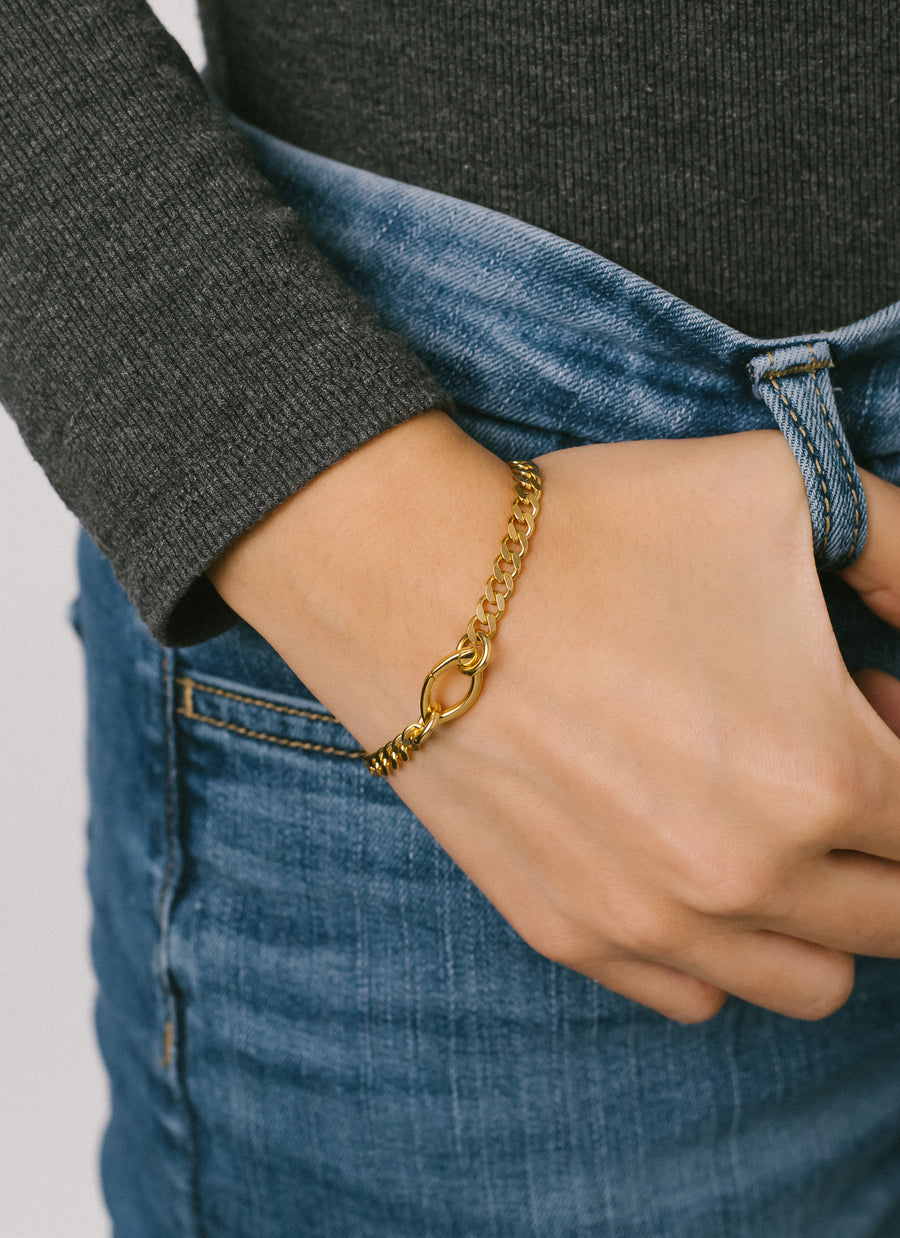 Female hand model wearing the gold vermeil unisex Gramercy curb chain bracelet from RIVA New York