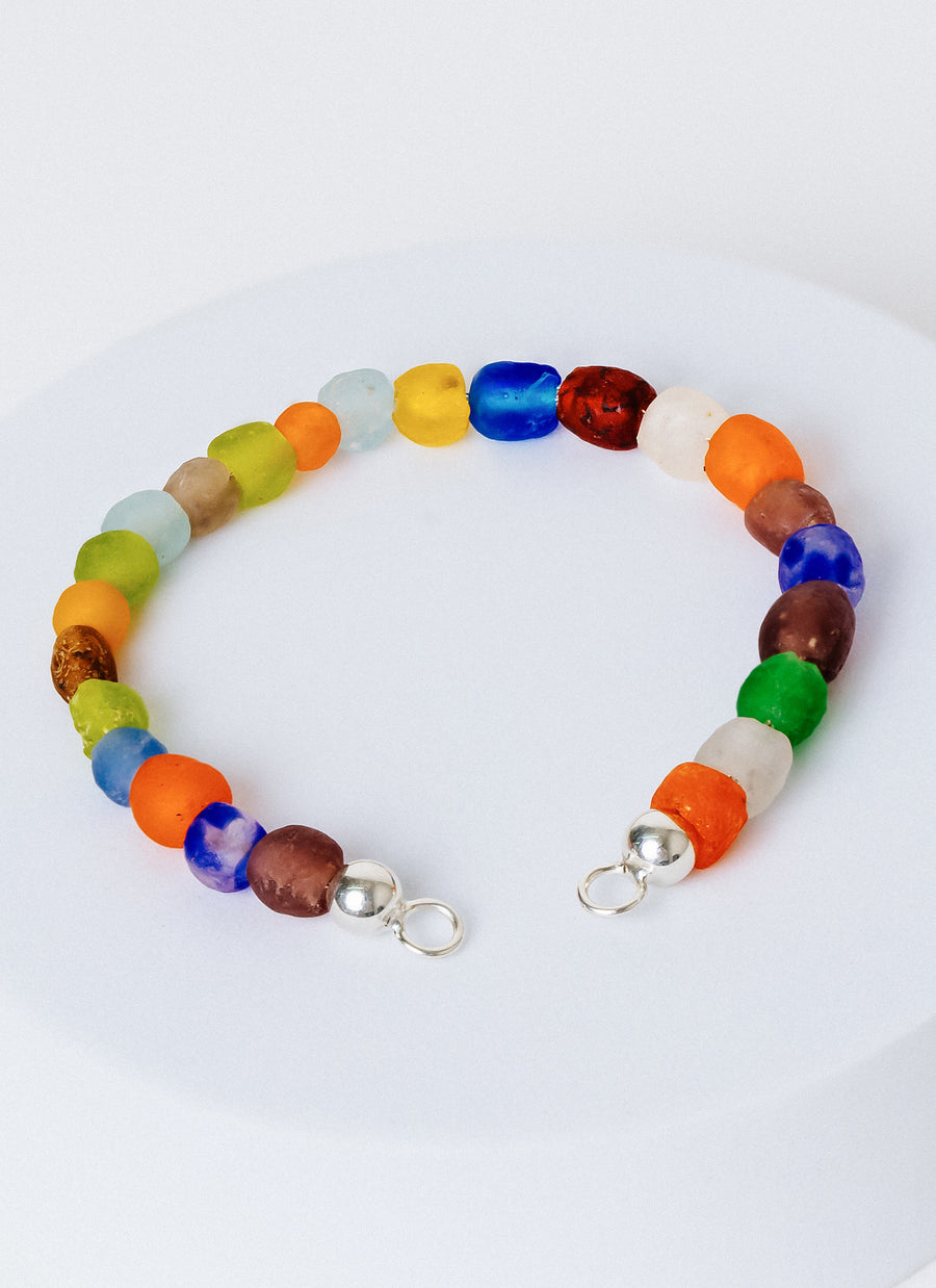 The Luna bead bracelet from RIVA New York, featuring multicolor recycled glass beads from the Krobo people in Ghana, and sterling silver accents; this item needs to be paired with an Invisible Clasp