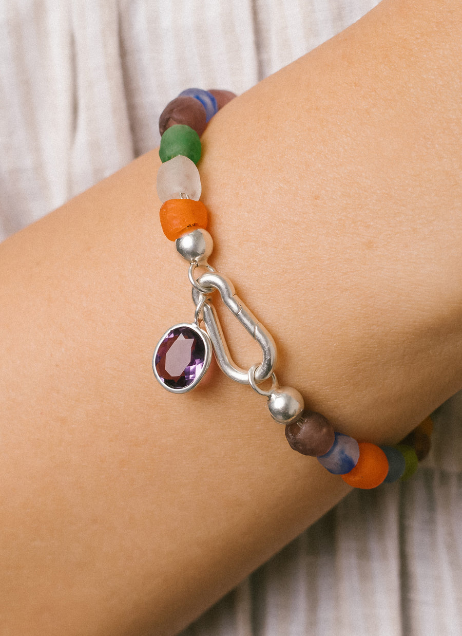 Oval amethyst charm from RIVA New York worn with carabiner clasp and Luna recycled glass bead bracelet