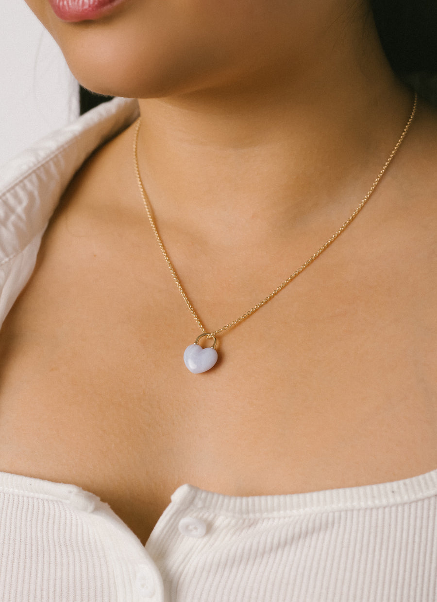 Model wears Chalcedony Heart Lock Pendant Necklace from RIVA New York
