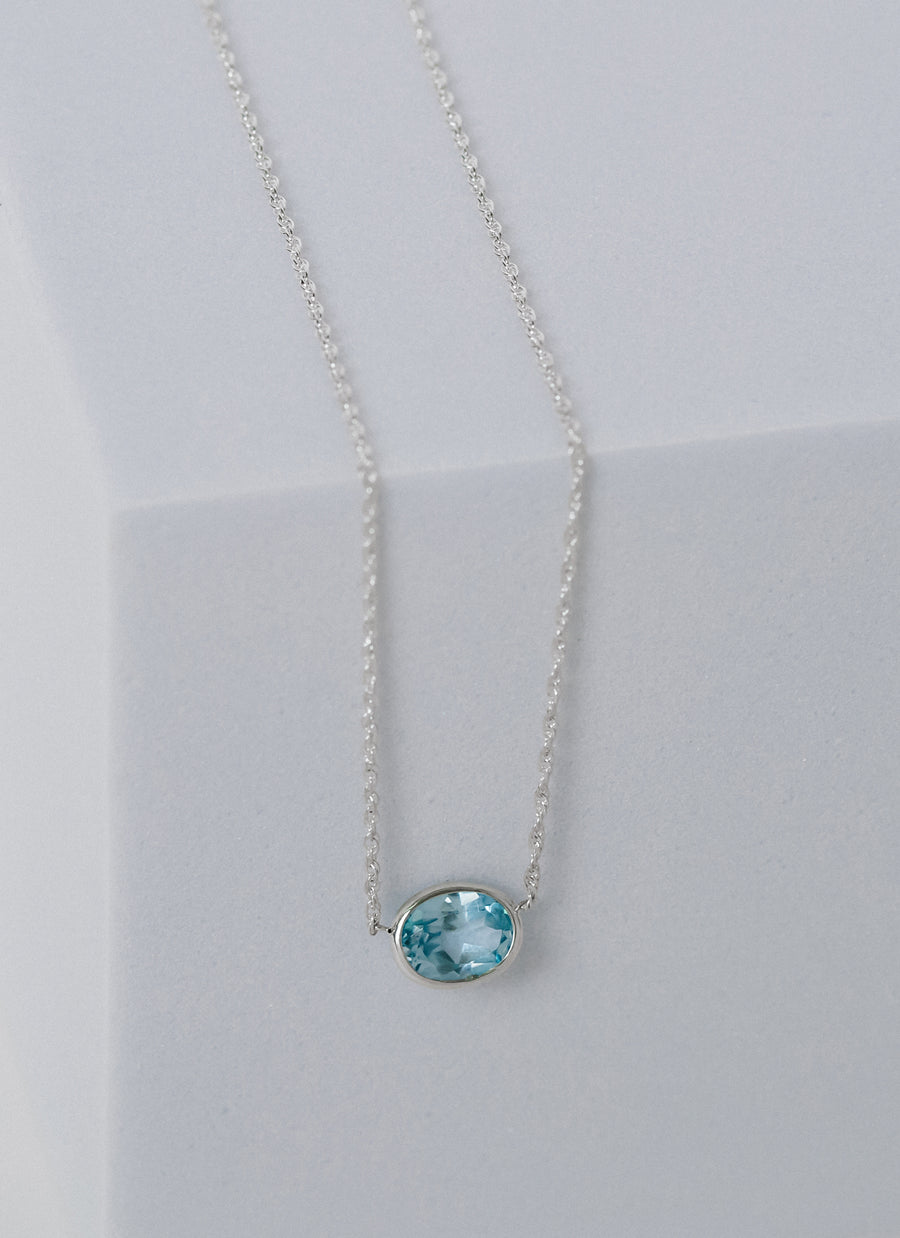 Photo of East-West Oval Blue Topaz Bezel Necklace from RIVA New York