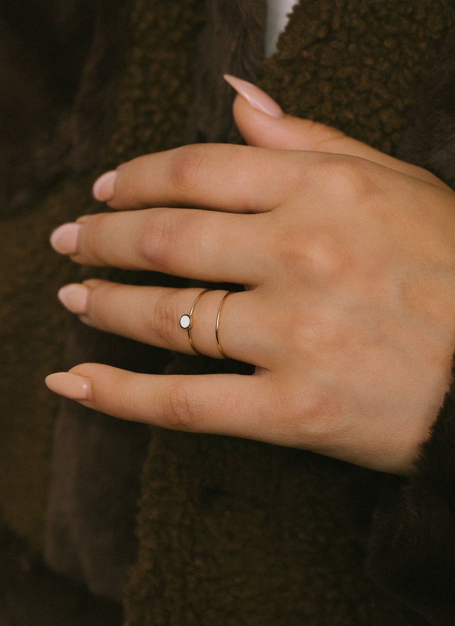 Model wears Enamel Accent Stacker Ring from RIVA New York, in 14k yellow gold with white enamel