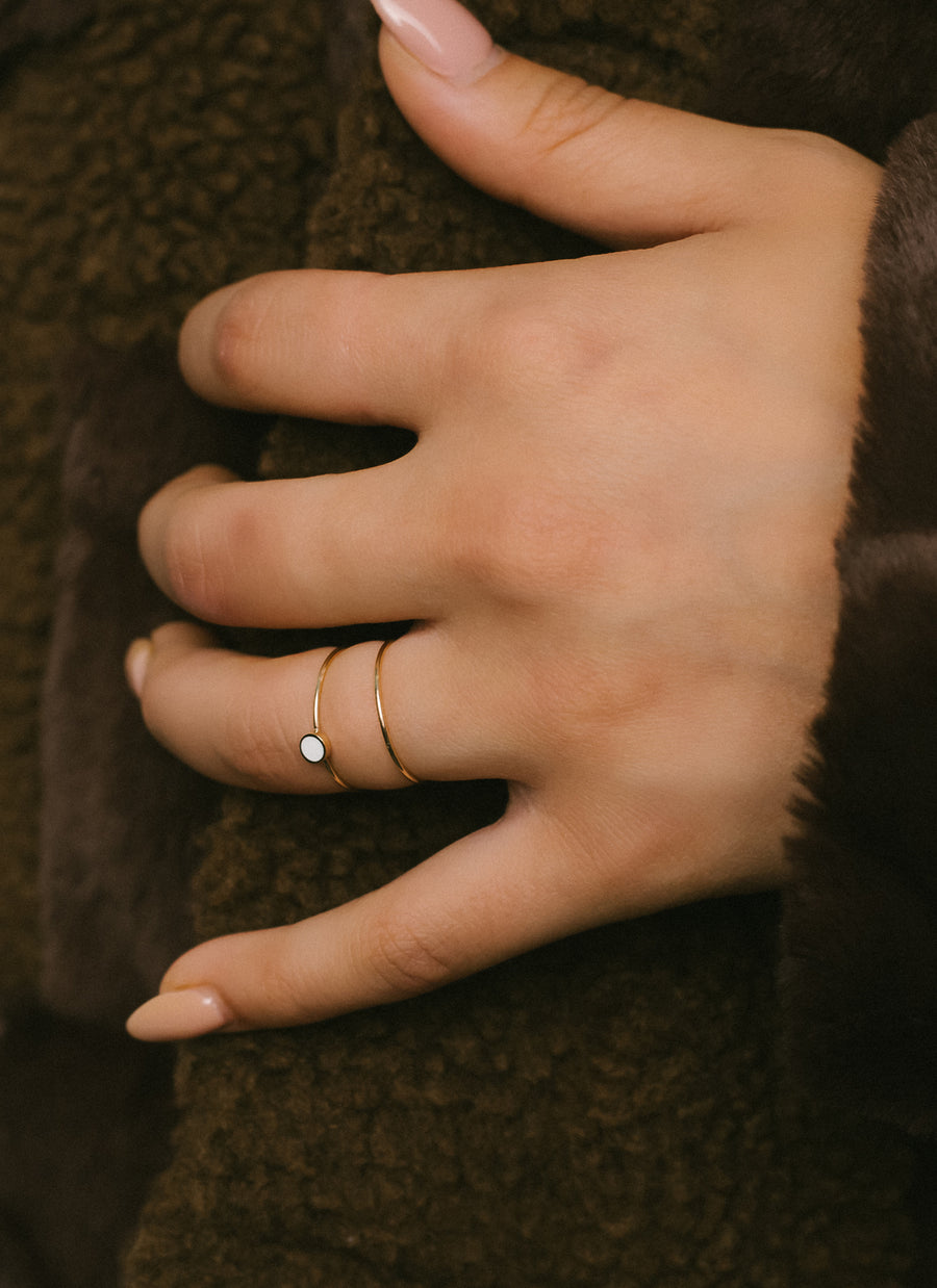 Classic stacker ring from RIVA New York in recycled 14K yellow gold, shown here paired with our enameled stacker ring in gold