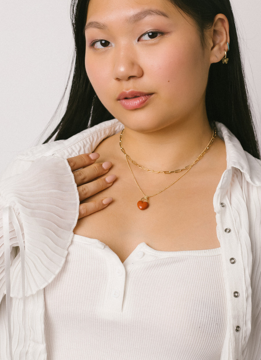 Model wearing RIVA New York's Red Jasper Heart Lock Pendant Necklace