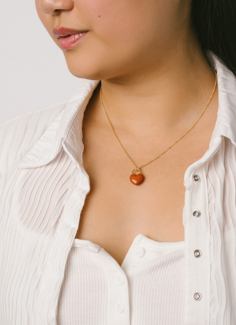 Female model wears Red Jasper Heart Lock Pendant Necklace from RIVA New York