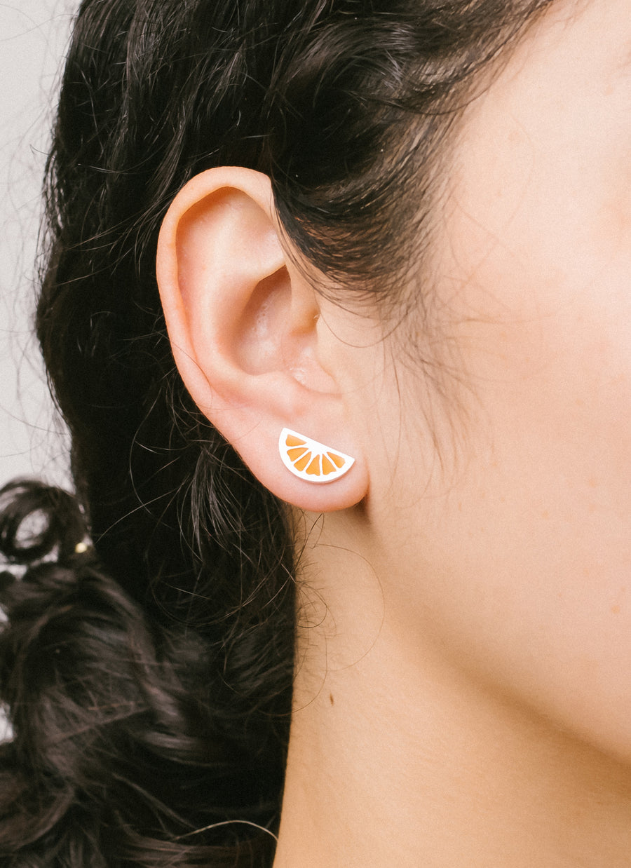 Sterling silver citrus wedge stud earrings with orange enamel, from RIVA New York