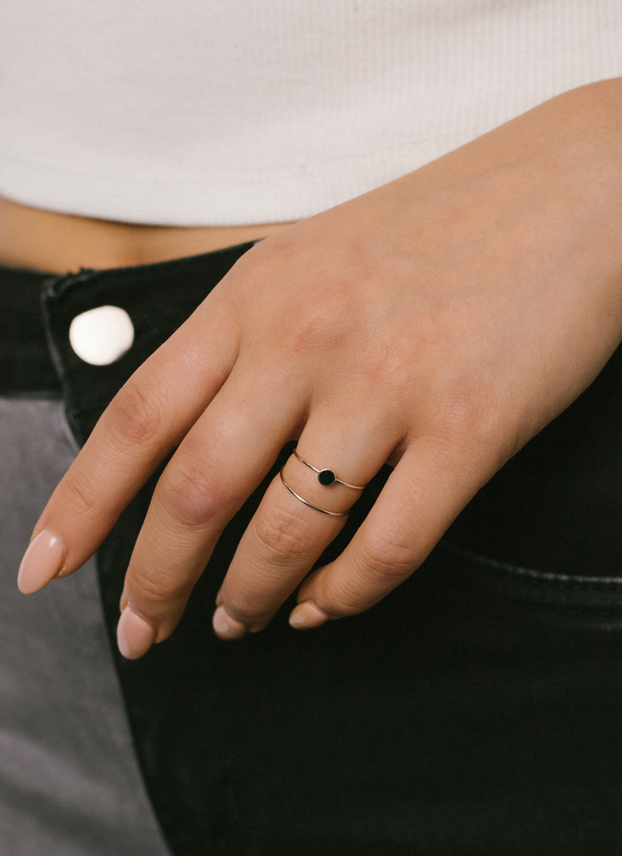 Model wears Enamel Accent Stacker Ring from RIVA New York, in sterling silver with black enamel