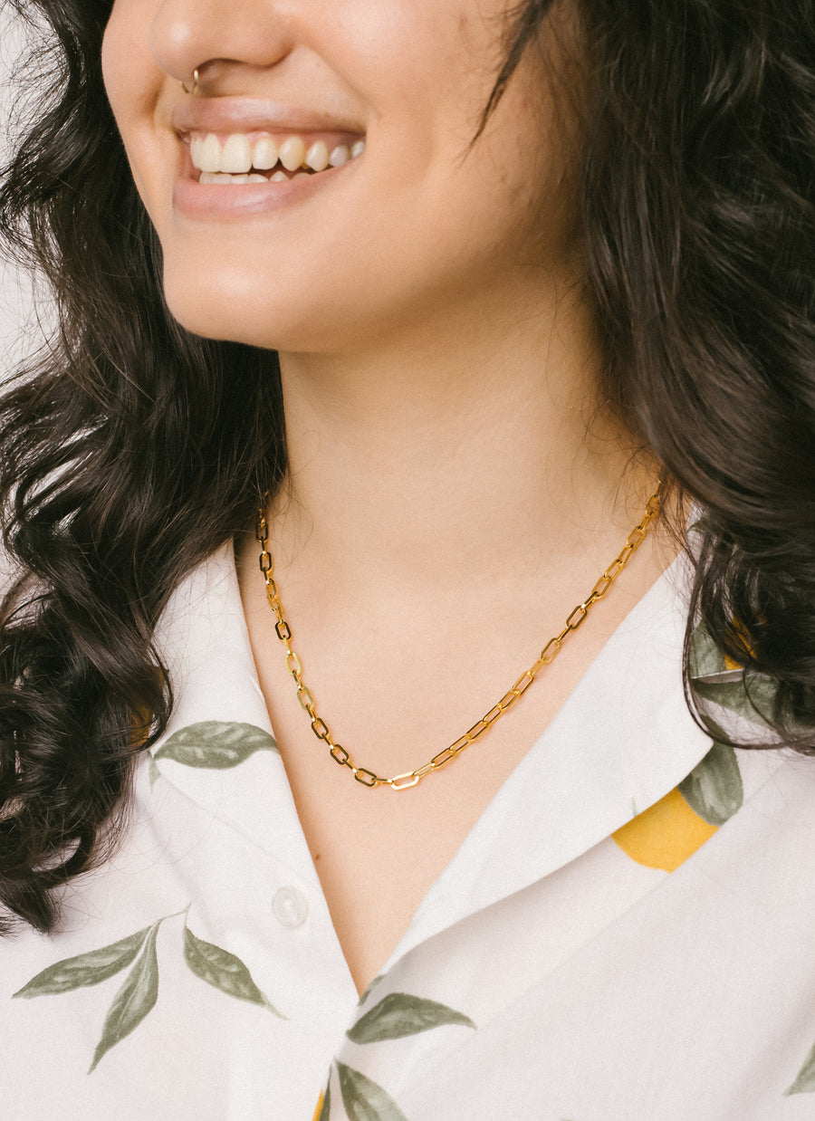 Model wearing RIVA New York's Astor paper clip chain necklace in gold vermeil