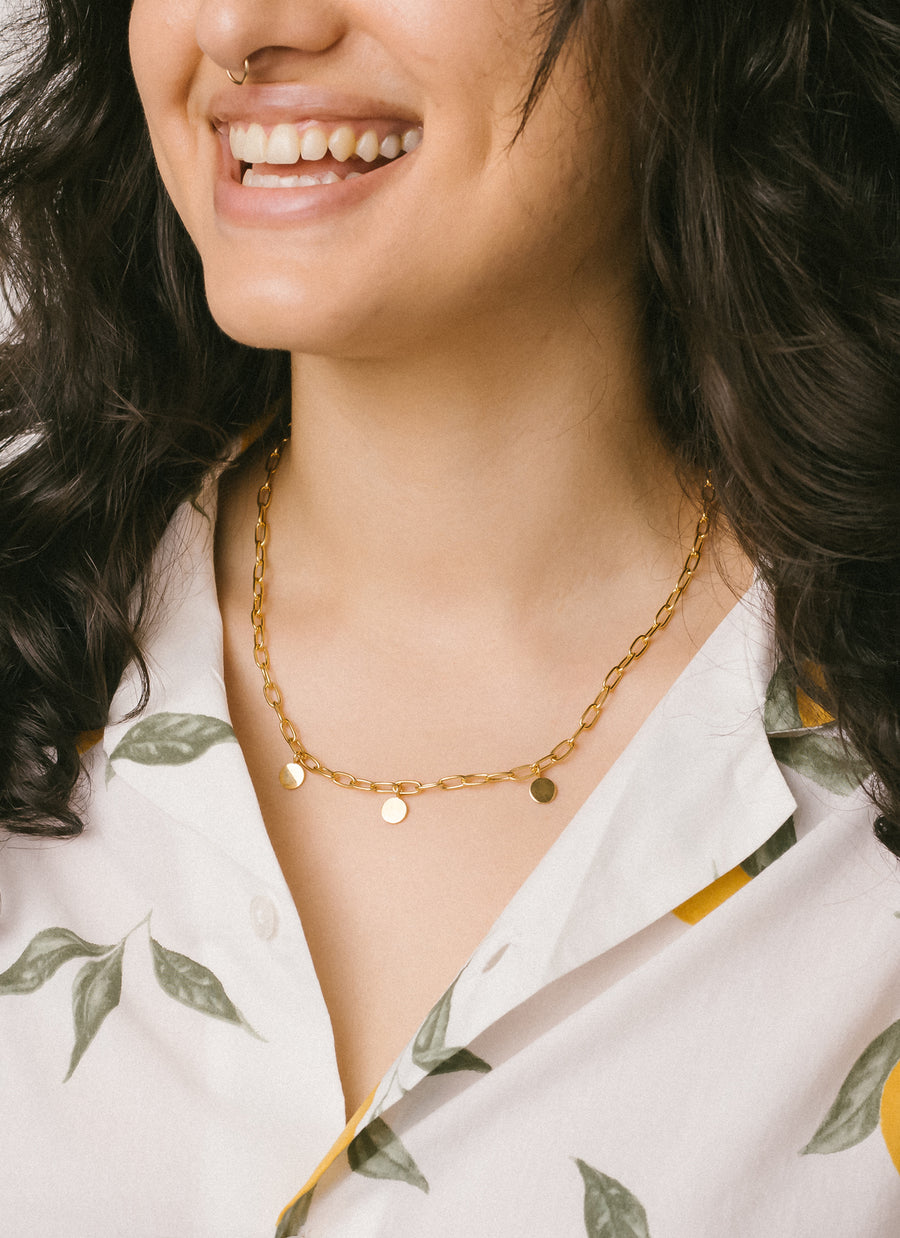 Model wearing RIVA New York's Madison Paper Clip Chain Necklace with Circle Charms in gold vermeil
