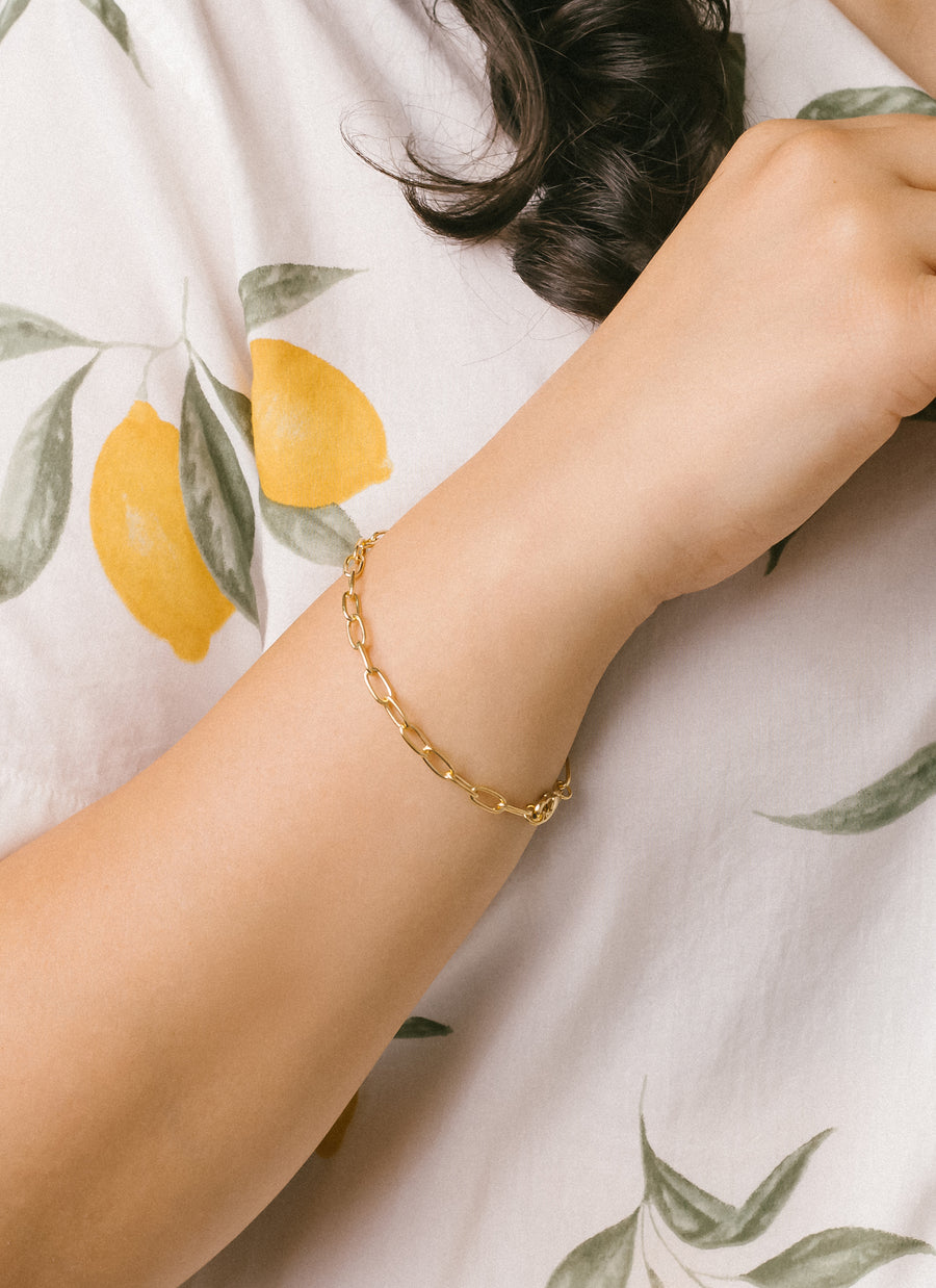 Model wearing Madison Paper Clip Chain bracelet in gold vermeil from RIVA New York
