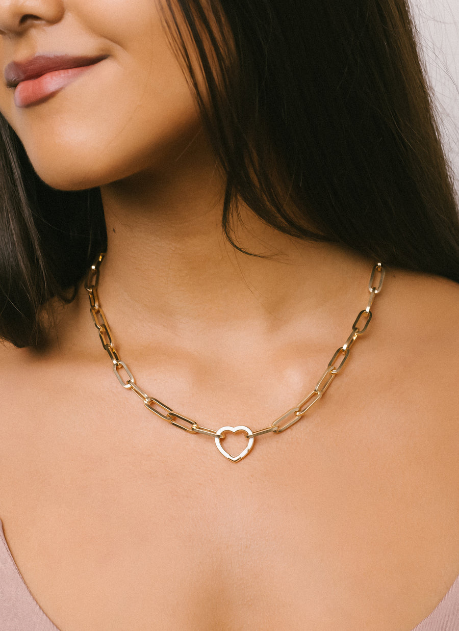 Sarah in the Wall Street paper clip chain necklace from RIVA New York in 14K yellow gold, with a heart-shaped enamel clasp