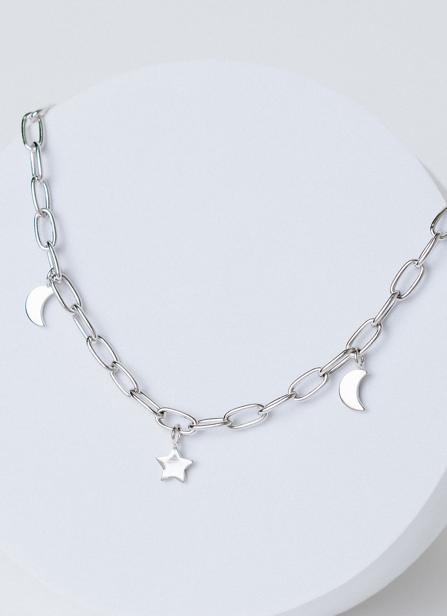 Paper clip chain necklace with star and moon charms in yellow sterling silver, from RIVA New York's spring 2022 release
