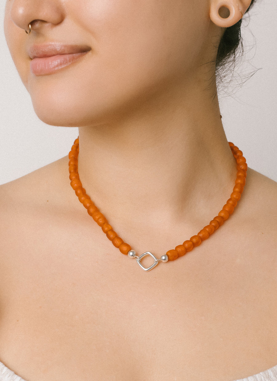 Rebecca wears RIVA New York's Sunset recycled glass bead necklace with cushion-shaped Invisible Clasp
